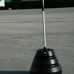 Conical water tank pole holder with banner